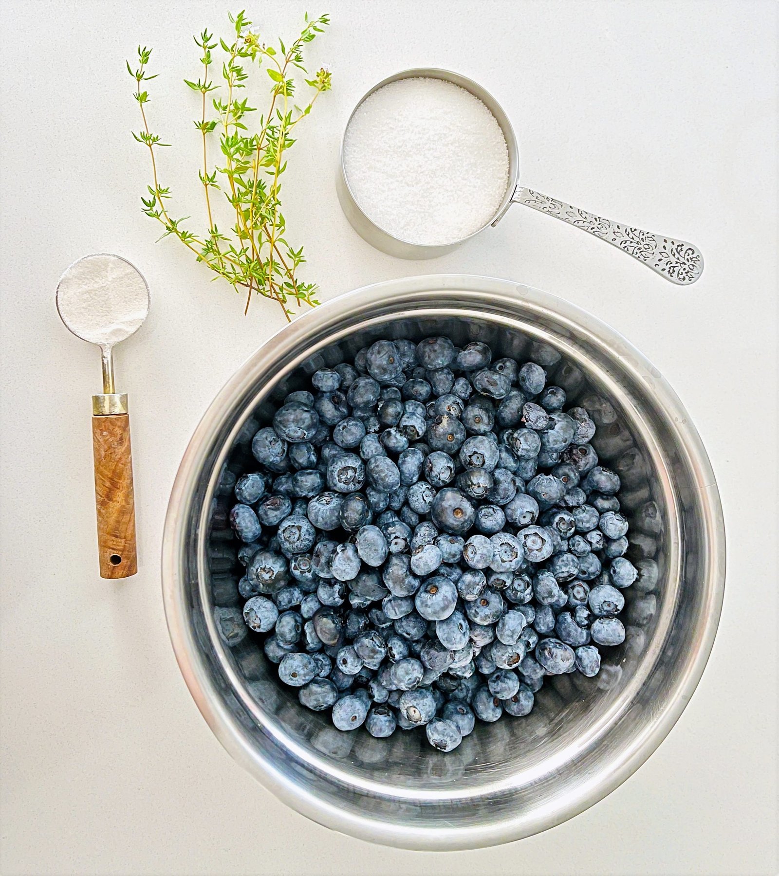 Blueberry Thyme Jam — bowl of blueberries with fresh thyme
