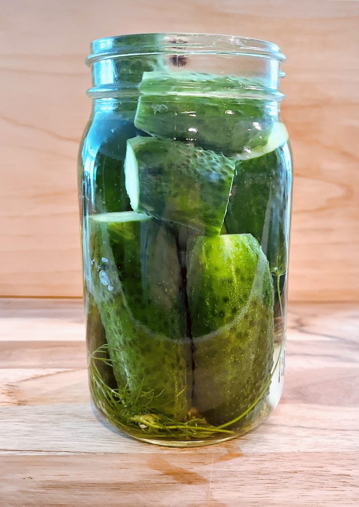 pack cucumbers in jars and add boiling water