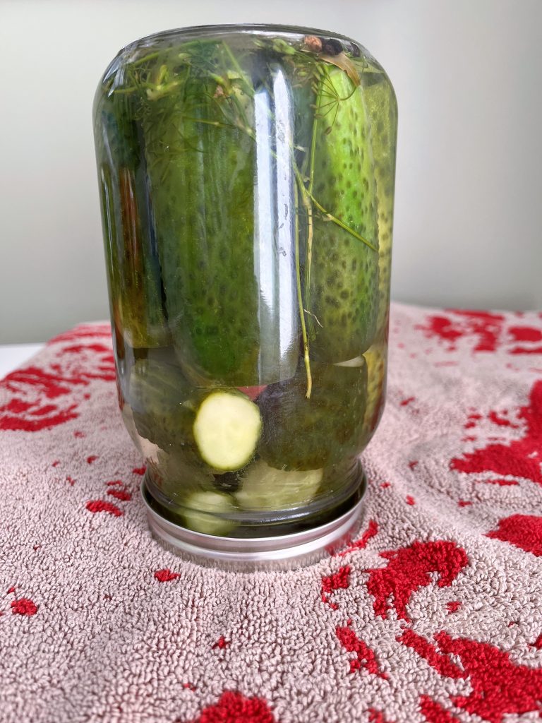 pour brine over pickles,  tighten lid, and flip the filled jar over bath towel