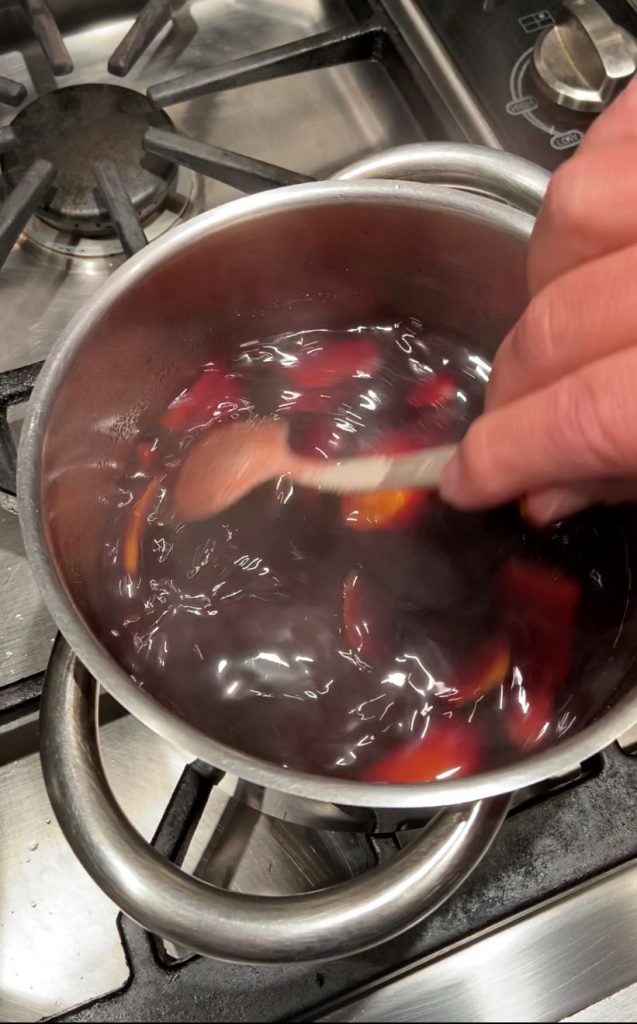 first step to make red wine jelly is to boil wine with orange peel