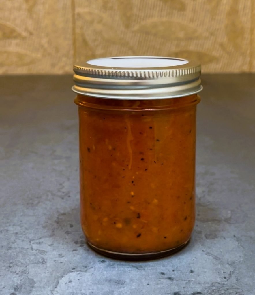 a jar of tomato sauce sealed with tattler reusable lid