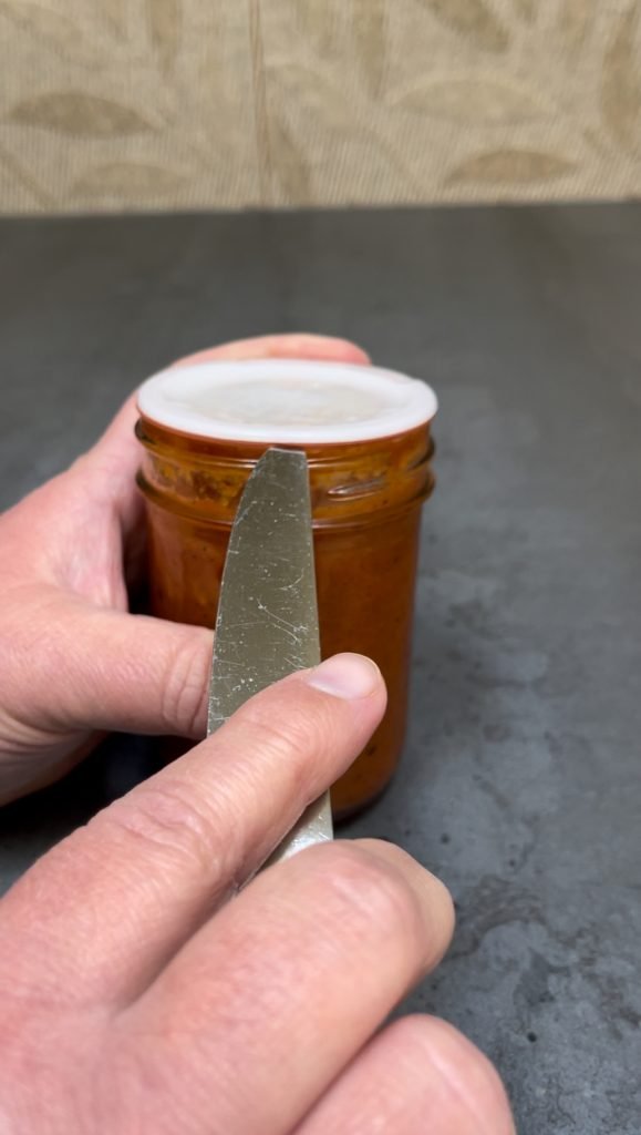 use kitchen knife to open the jar sealed with tattler reusable lid