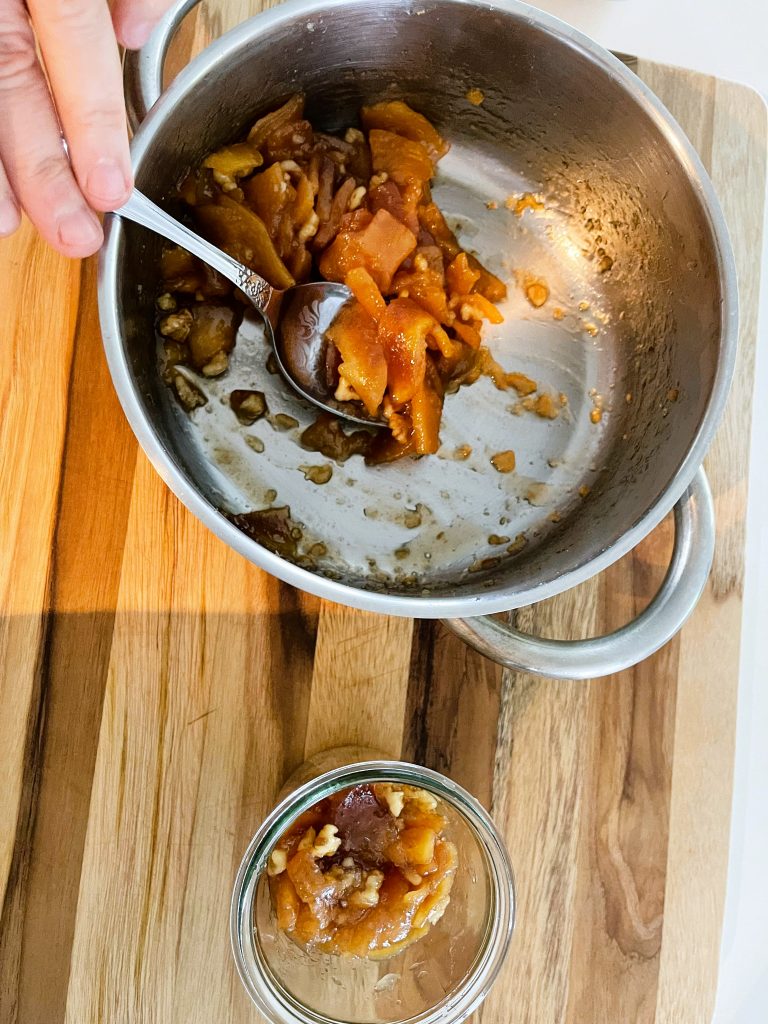 pack walnut quince jam into sterilized jars