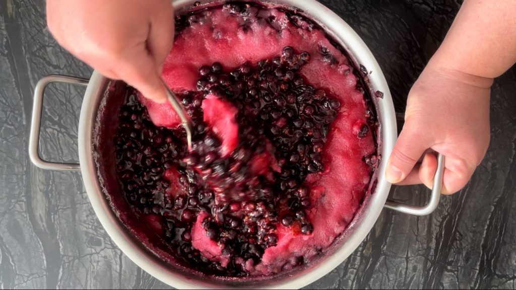 we're mashing berries with sugar for this blackcurrant recipe