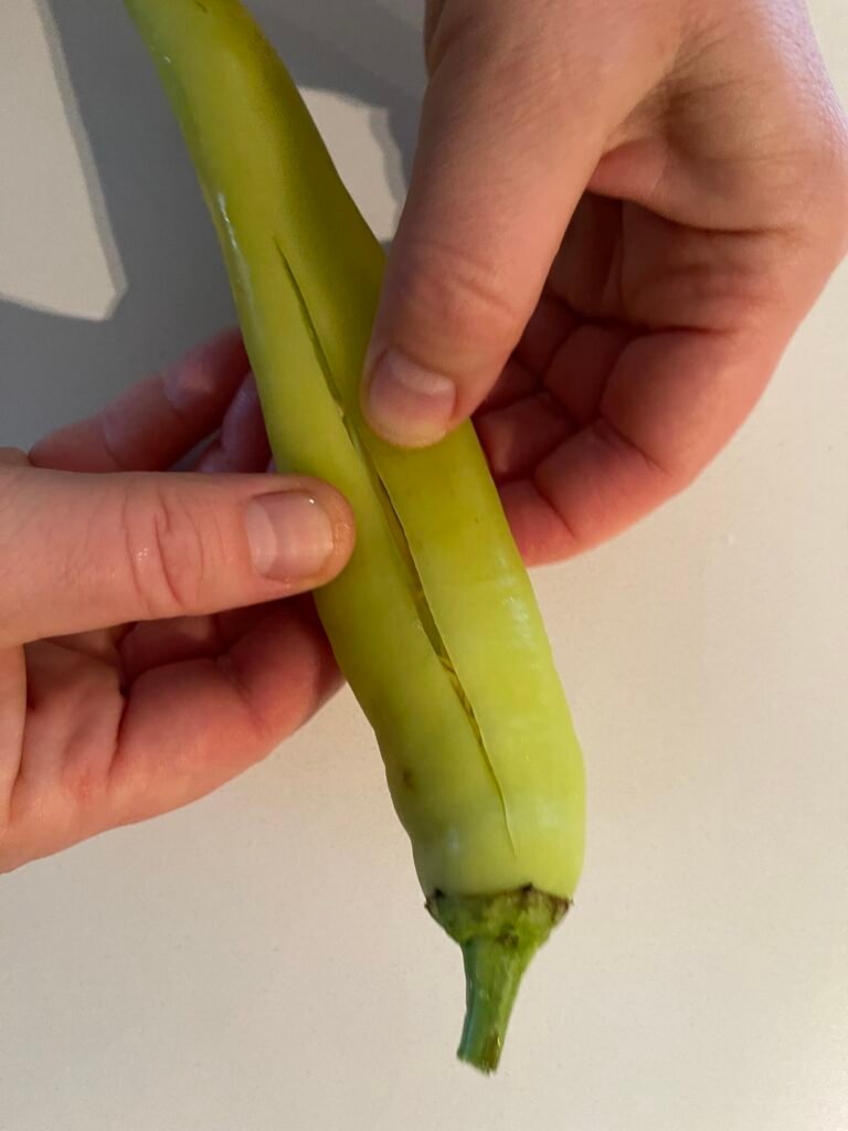 make a horizontal side cut in each banana pepper 