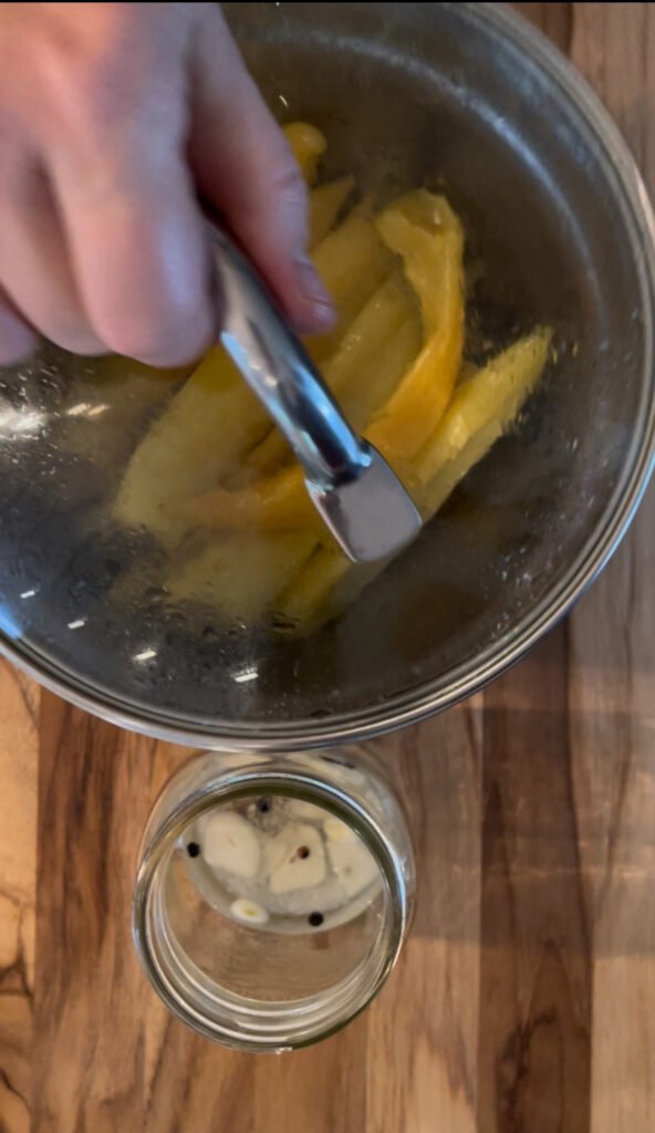 Pack fried banana peppers into the canning jars on top of the brine ingredients