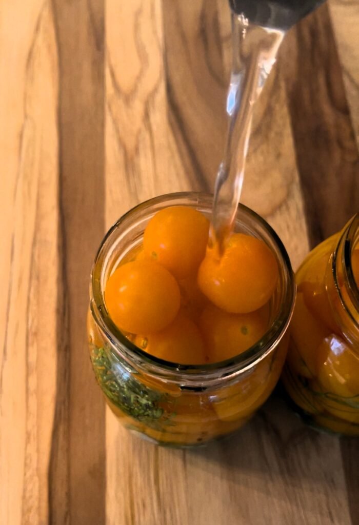 to make canned cherry tomatoes pour hot brine into  thepacked jars