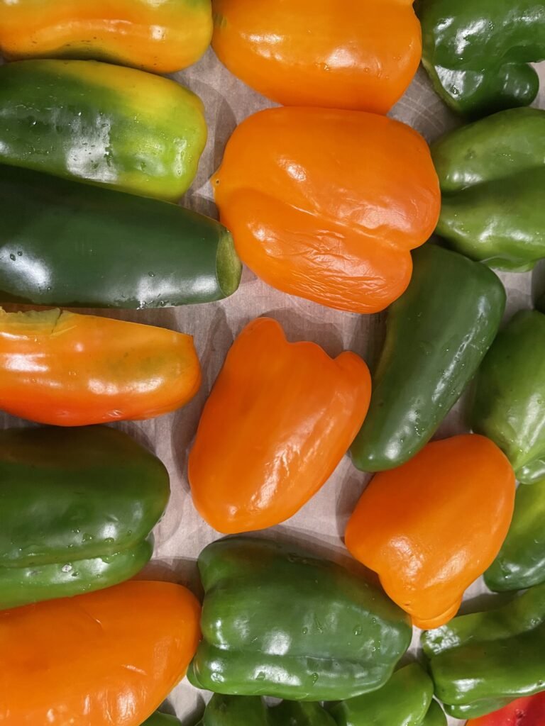 sliced and de seeded peppers on a parchment lined tray 