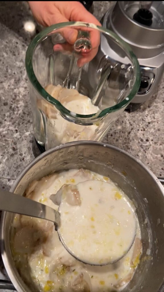 sunchoke soup gets poured into a blender 