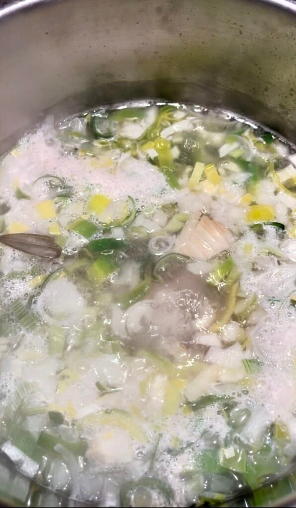 impurities form on the surface of the fish stock as it starts to simmer