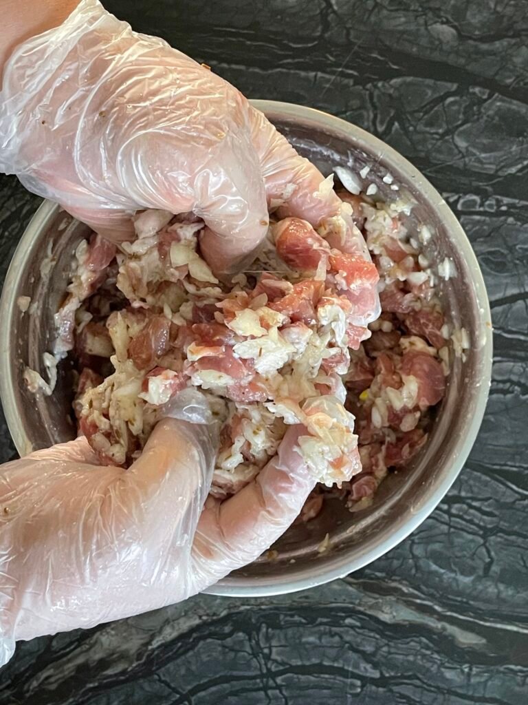 combine minced onion with diced meat with your hands