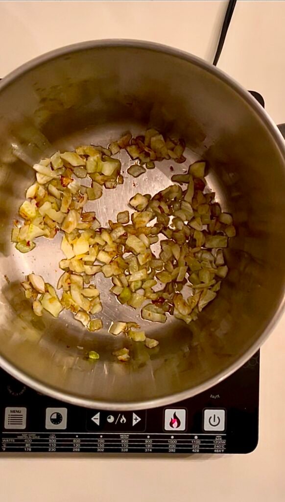 diced fennel gets browned in a pot