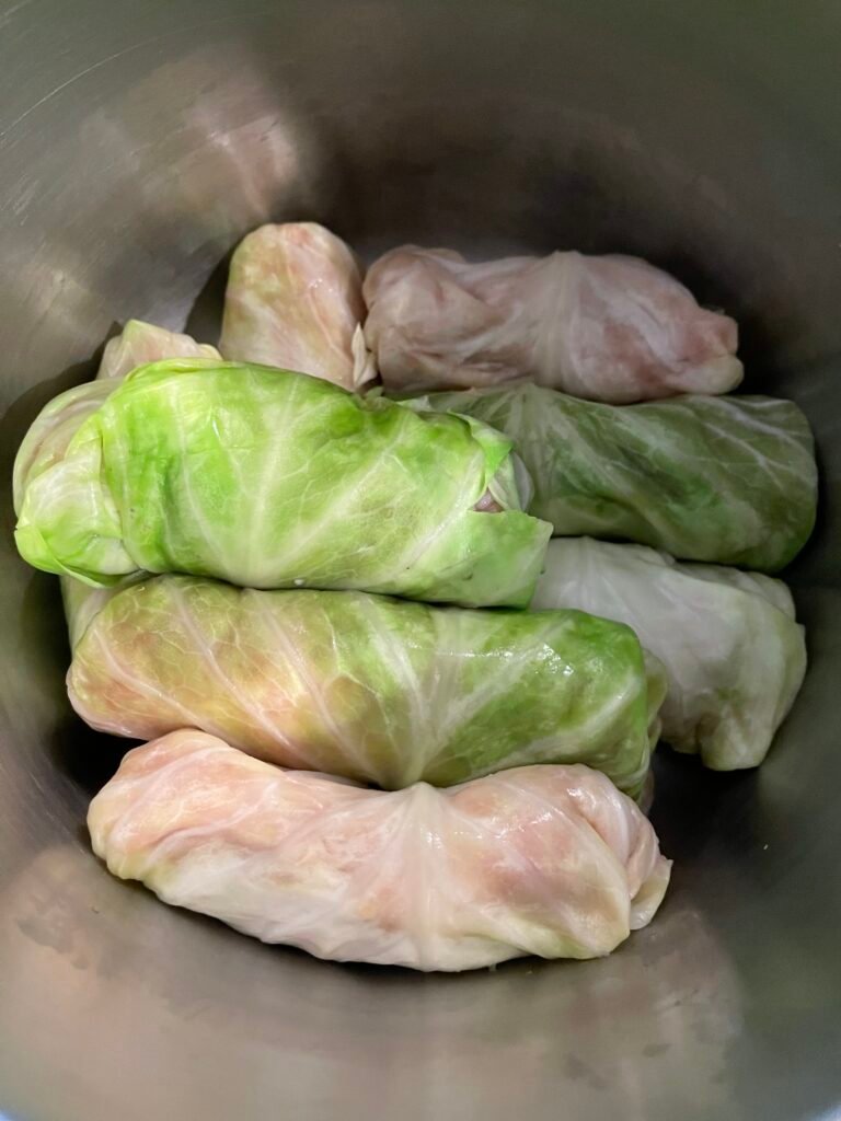 Arrange the cabbage rolls, seam-side down, in layers