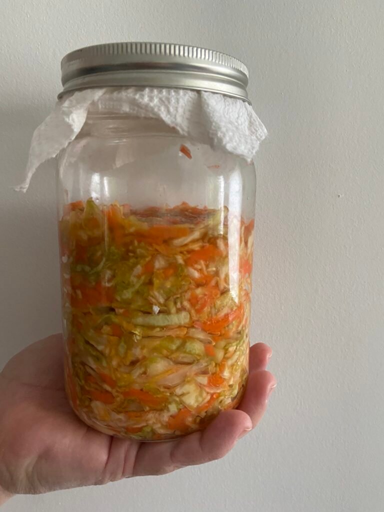 cabbage and carrot mixture is tightly packed into the fermenting vessel