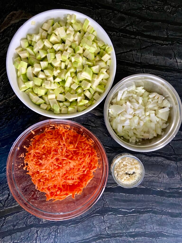 shredded carrots and diced onions, garlic and zucchini ready for this zucchini spread recipe