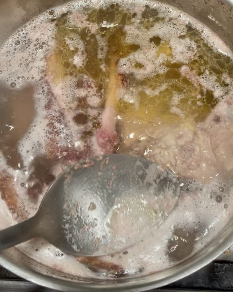 use a large spoon to skim impurities off the surface of the stock