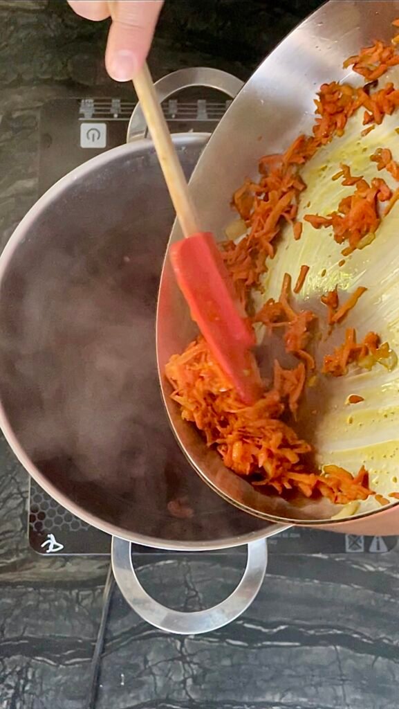 sauté shredded carrots before adding them to the po