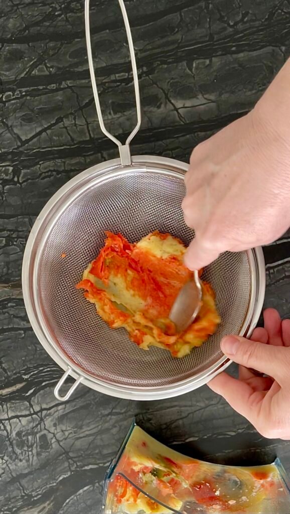 using spoon push pulp through the fine mesh strainer