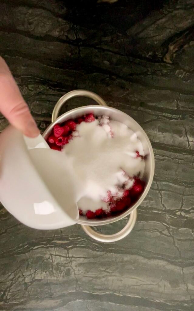 start by adding all of the sugar to the cleaned raspberries