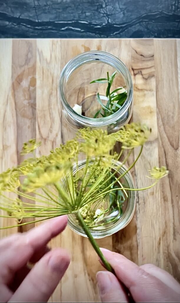 dill head gets added to a quart jar filled with the rest of the spices