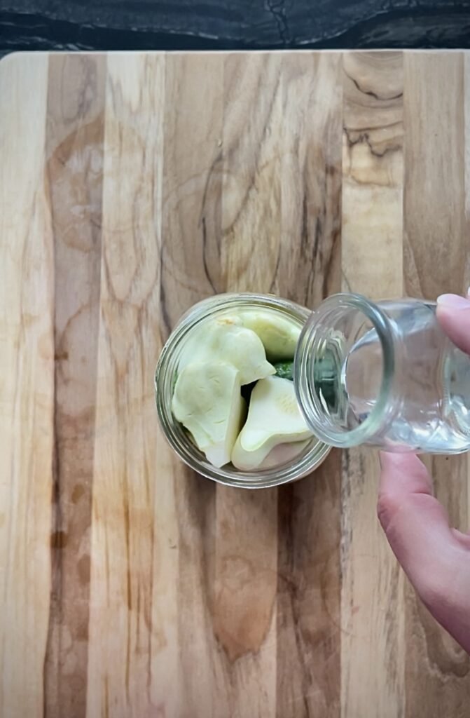 we top each jar with pickling vinegar first