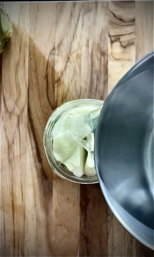 we pour pipping hot water-salt-sugar mix on top of the vegetables