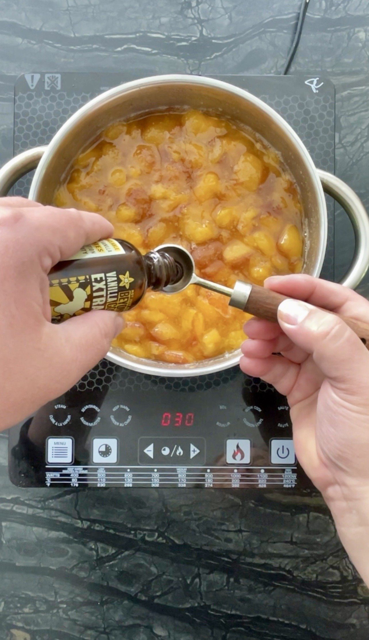 adding vanilla extract to our plum jam