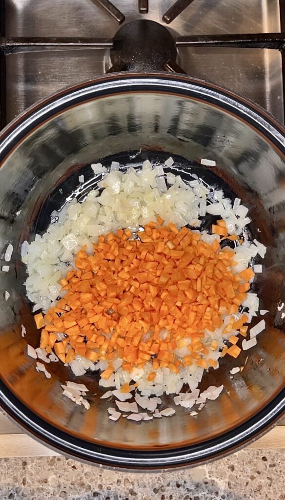 chopped carrots get added to the pot with fried onions