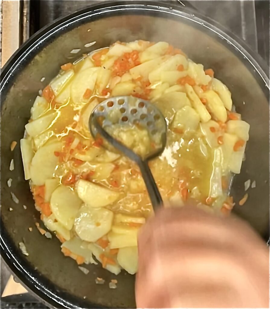potatoes get crushed with potato masher