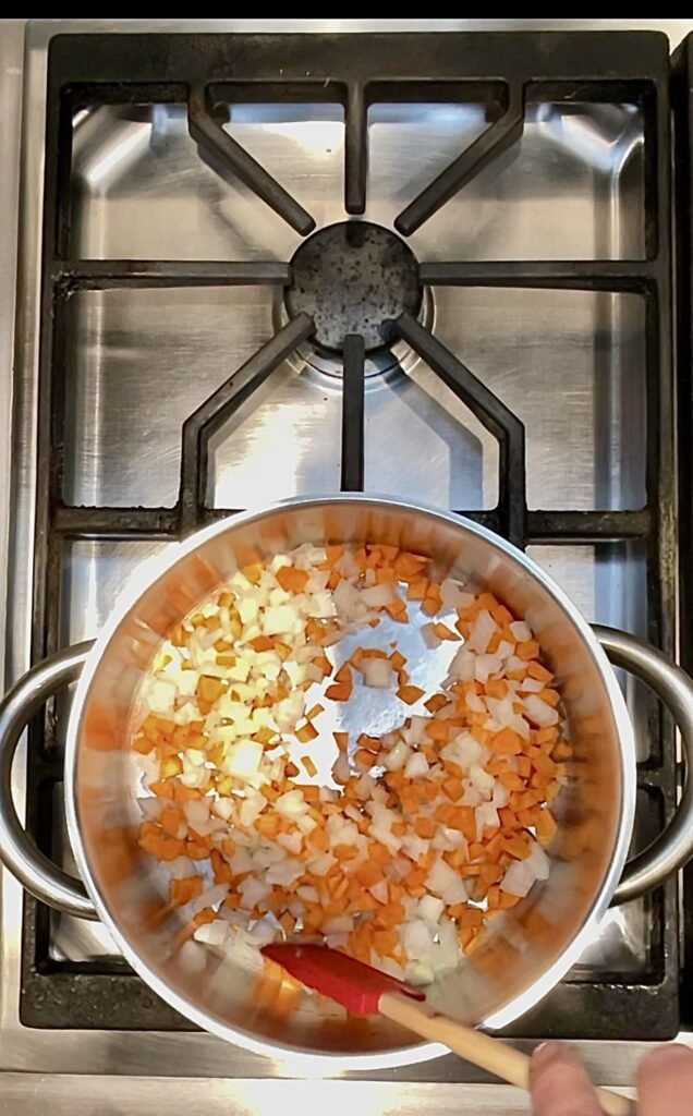 start the soup by sauteing onions and carrots together