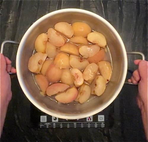 fully cooked apples  and the cooking juices pictured in the heavy bottomed pot used for cooking