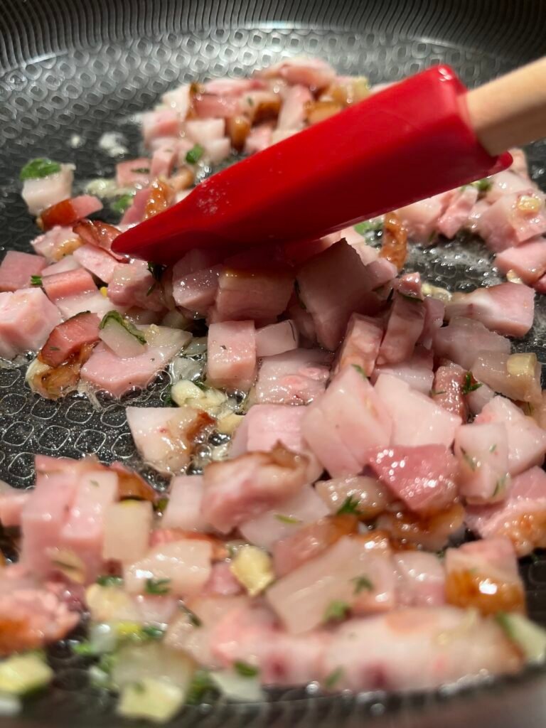 pancetta and herbs are lightly fried in a skillet