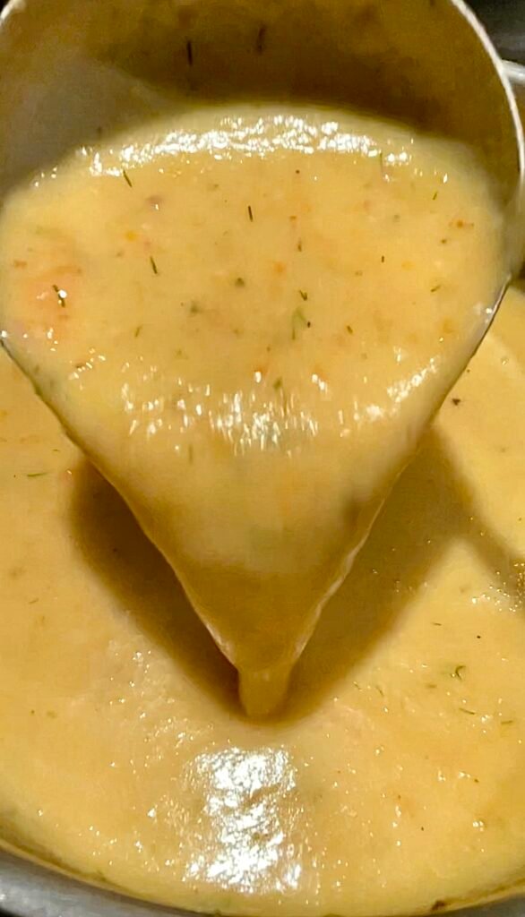 fully cooked potato keek and bacon soup looks creamy and has lots of dill