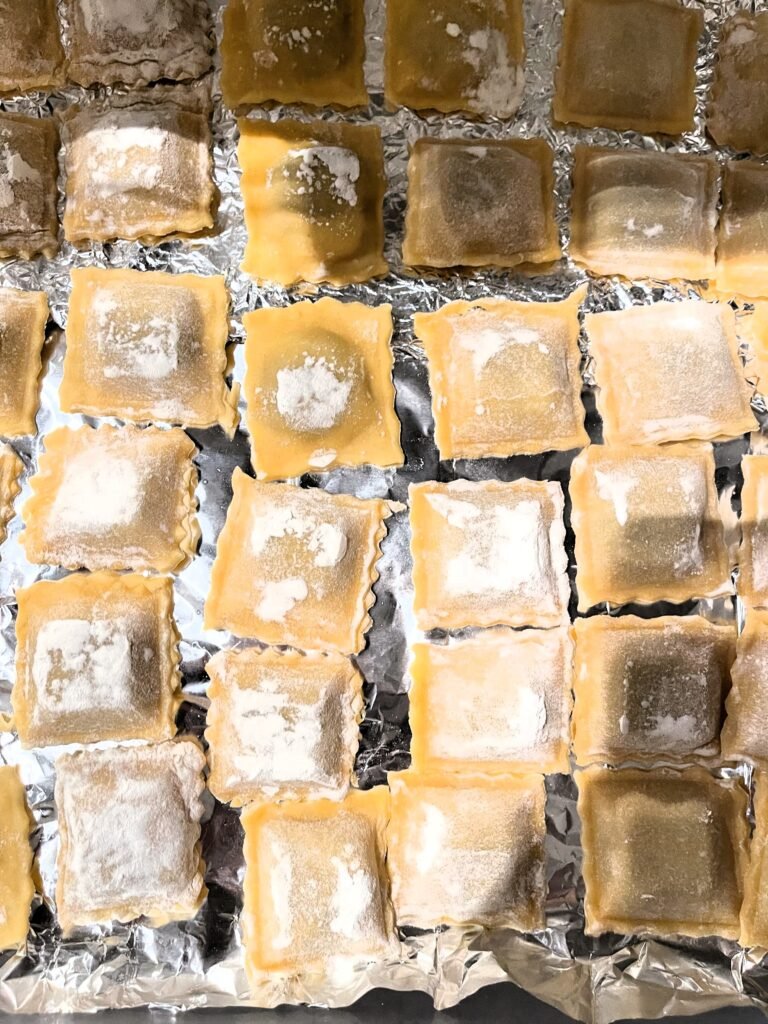 freshly made ravioli placed on a flat surface in our freezer