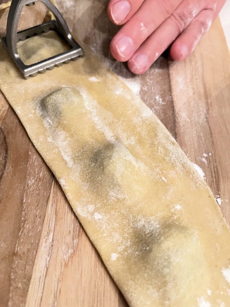 place second sheet of dough on top of the filling and stamp ravioli