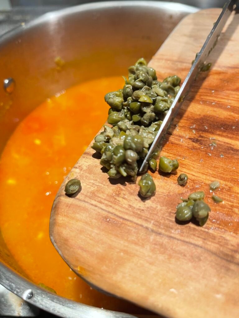 add chopped capers to the cooking soup