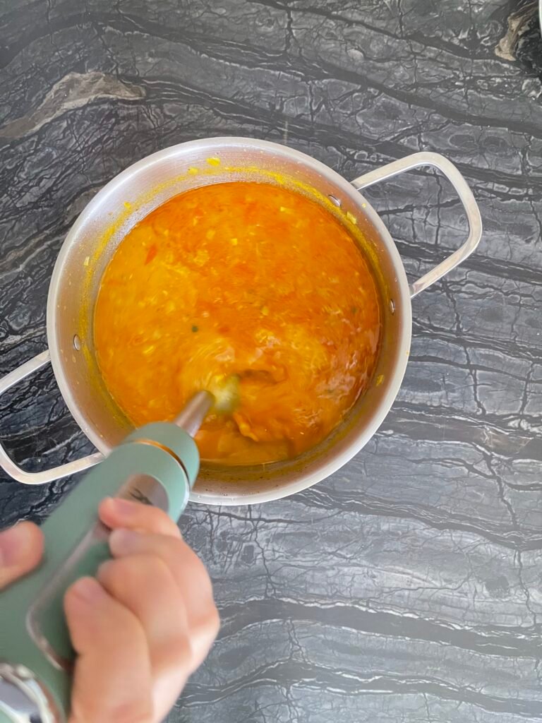 handheld blender is used to blend cooked soup