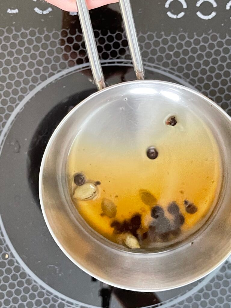 only two tablespoons of cardamom - juniper berry infusion remain in the sauce pan