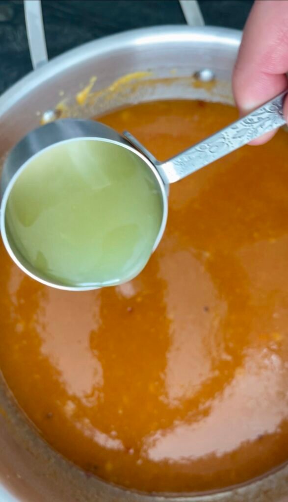hot pepper jam prep - add lime juice to the pot with a jam mixture