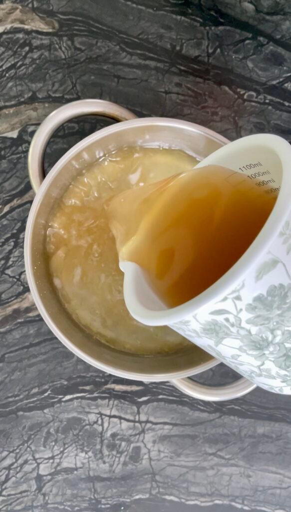 Apple lemon balm jelly strained lemon balm apple juice added to the pot