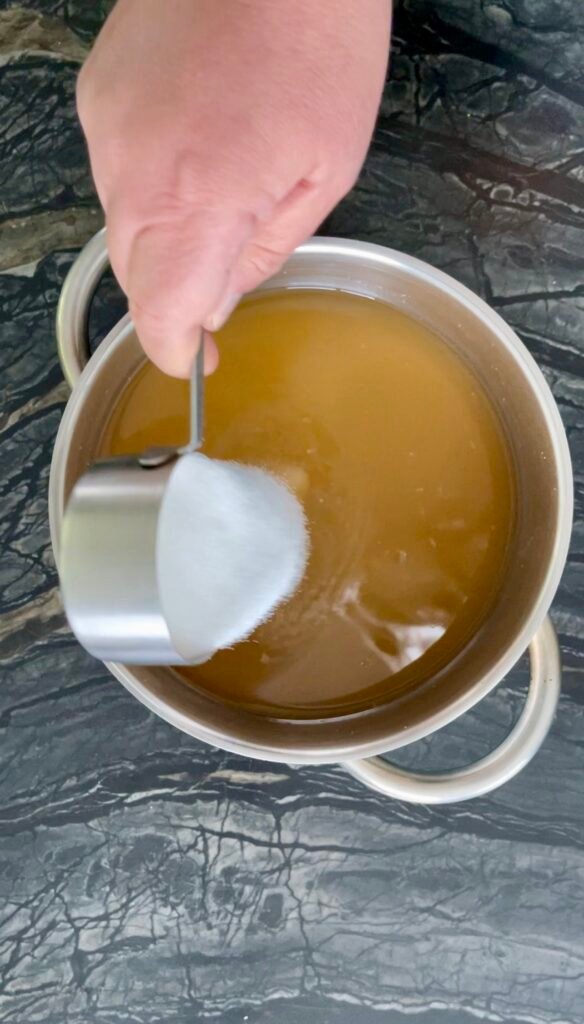 Apple lemon balm jelly adding powdered pectin mixed with sugar