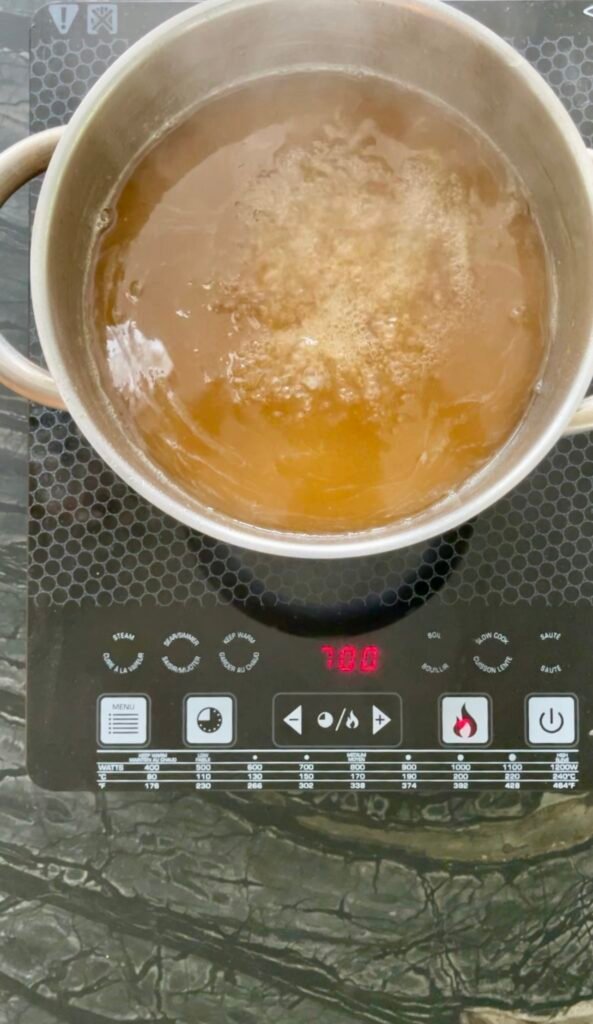Apple lemon balm jelly at full rolling boil before set test