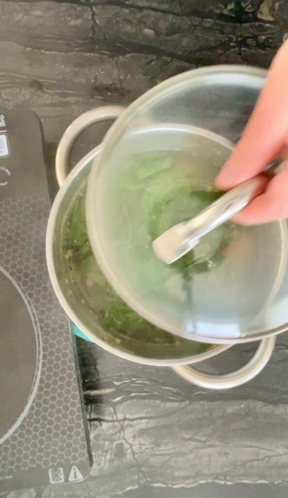 apple balm jelly - Covered pot of lemon balm steeping in apple juice