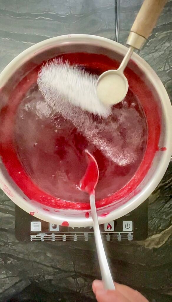 sugar and Pomona's pectin added to the strained raspberry pulp and juices