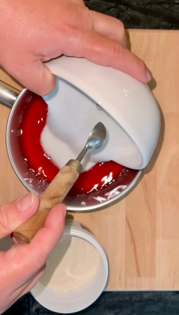 sugar-pectin mix added from the bowl to a jelly mixture