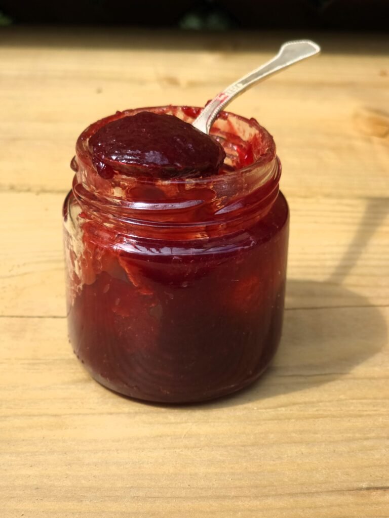 Seedless raspberry jam in a spoon
