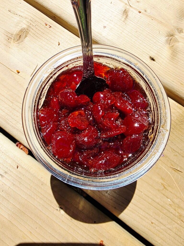  finished jars of whole cherries in glossy syrup