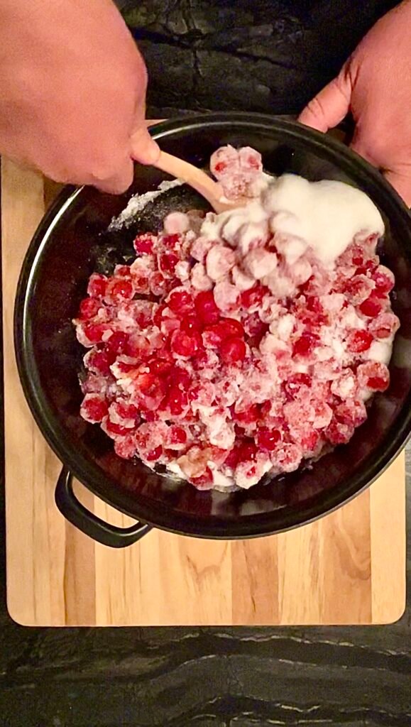 pitted cherries with sugar in the pot before macerating