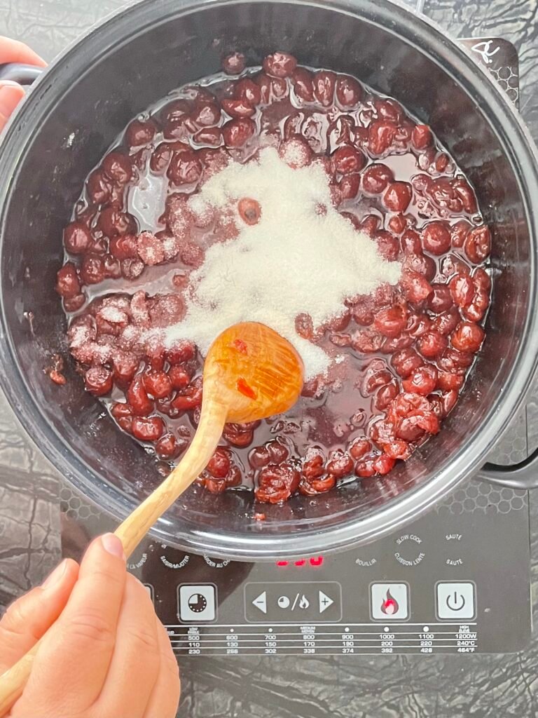 sugar and pectin mixed in a sour cherry jam mixture