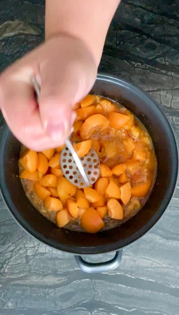 peach apricot lavender jam: folding in the halved apricots before the second mash